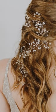 Portrait of a woman with long hair wearing jewelry representing Debonaire services